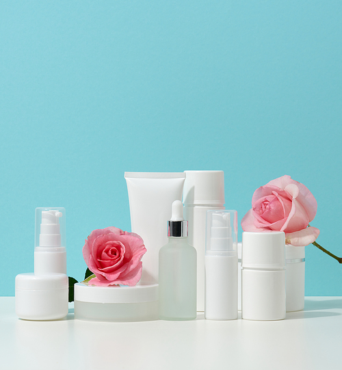 jar, bottle and empty white plastic tubes for cosmetics on a white table. Packaging for cream, gel, serum, advertising and product promotion, mock up