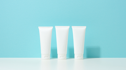 empty white plastic tubes for cosmetics. Packaging for cream, gel, serum, advertising and product promotion, mock up