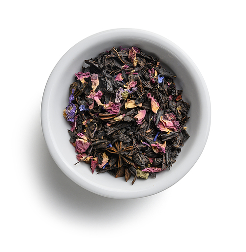 Black tea with natural aromatic additives. Top view on white background.