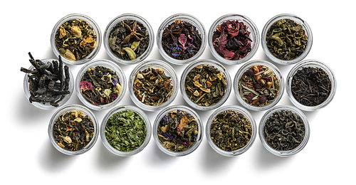 Large assortment of tea on a white background. The view from the top.