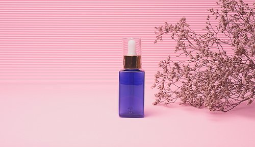 blue glass bottle with a dropper for cosmetics on a pink background. Packaging for gel, serum, advertising and promotion. Natural organic products. Mock up