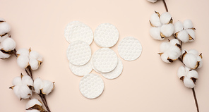 White cotton sponges on beige background. Design for the beauty, medicine and cosmetics industry