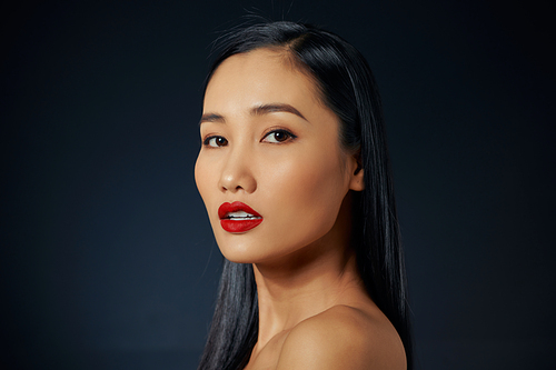 Asian beautiful woman with red lipstick isolated on black background. copyspace.