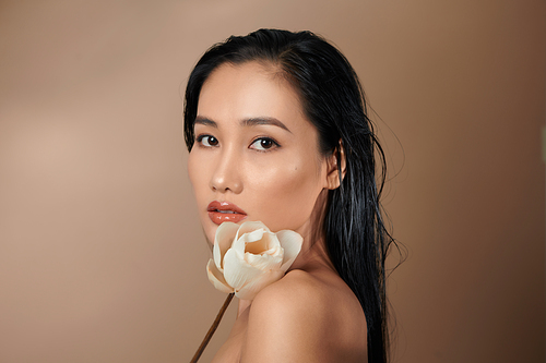 Beautiful girl with dried lotus buds. Beauty model woman face. Perfect skin.