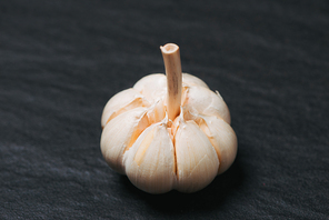 Fresh garlic. Garlic Bulb on black stone table.