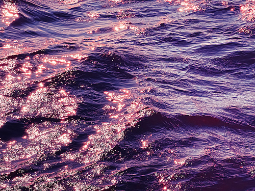 Sea, texture and coastal nature concept. Ocean water at sunset as surface background.