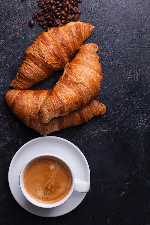 Top view of traditional croissants with hot coffee. Golden croissants.