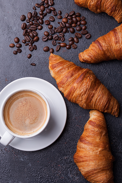 Top view of coffee and croissant with coffee beans. Delicous coffee.