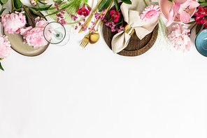 Spring table setting concept - beautiful pink flowers, trendy crockery and cutlery flat lay, copy space