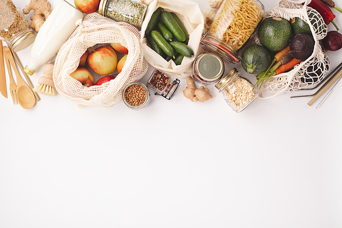 Zero waste concept. Eco bags with fruits and vegetables, glass jars with beans, lentils. Eco-friendly shopping, flat lay