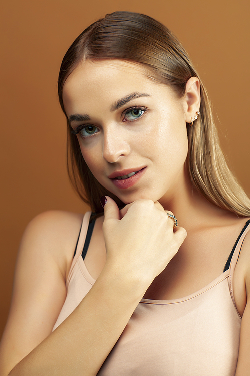 young pretty blond woman with fresh natural makeup posing cheerful on browm background, lifestyle people concept closeup