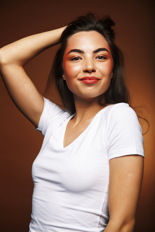 pretty girl happy posing: brunette on brown background, lifestyle people concept close up