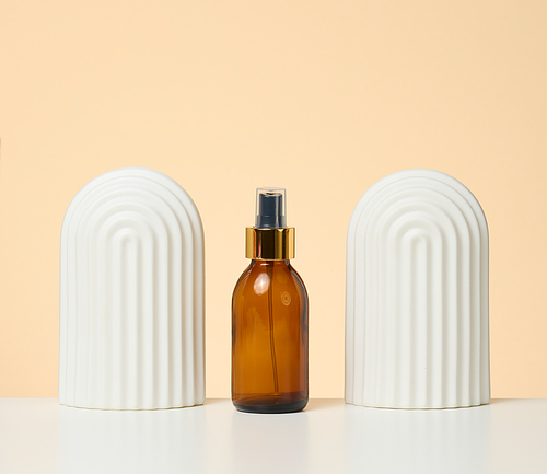 brown glass bottle with spray on white background. Cosmetics SPA branding mockup