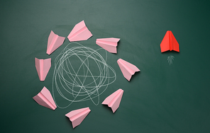 group of pink planes fly in a circle with an intricate trajectory and one flies in a straight path. The concept of thinking outside the box, uniqueness. Fast business solutions