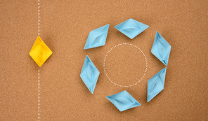 a group of blue boats floats in a circle and one floats along a straight path. The concept of thinking outside the box, uniqueness. Fast business solutions