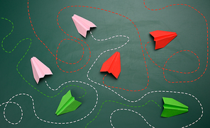 group of paper planes with long tangled paths on a green background. concept of a strong leader with extraordinary thinking, quick decision-making. Finding the optimal and simple solution in business