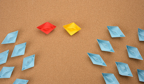 group of paper boats on a brown background. concept of a strong leader in a team, manipulation of the masses, following new perspectives, collaboration and unification