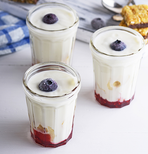 glasses with homemade yogurt and raspberry syrup, close up