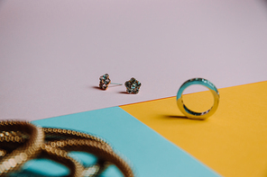 Colorful concept shot of jewelry with rings and earrings with three colors and minimal style