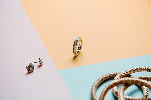 Colorful concept shot of jewelry with rings and earrings with three colors and minimal style