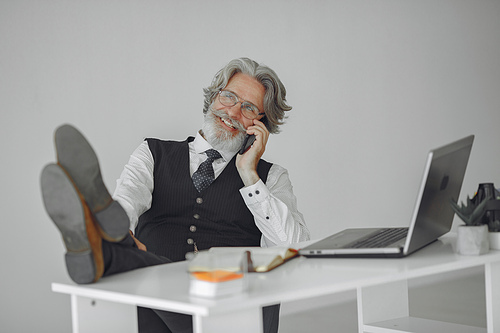 Elegant man in office. Businessman in white shirt. Man works with phone.