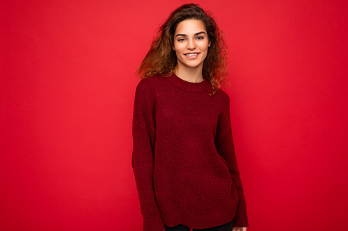 Photo of beautiful positive smiling adult woman wearing stylish clothes standing isolated on colorful background with copy space looking at camera.