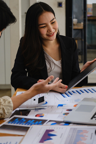 For the investigation of a corruption account, a group of businesswomen and accountants search data documents on a laptop. definition of anti-bribery
