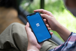CHIANG MAI, THAILAND: JULY 19, 2021: LinkedIn logo on phone screen. LinkedIn is a social network for search and establishment of business contacts. It is founded in 2002.