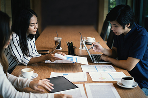 Group of business people discuss current financial and economic paperwork for investment at the meeting. Analytics intelligence concept