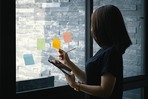 Asian Business woman taking note on digital tablet