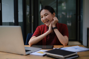 A happy woman has a business meeting with her team through video call In a cafe