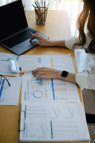 A female investment consultant examines the yearly financial report of a corporation. Stock market, office, tax concept