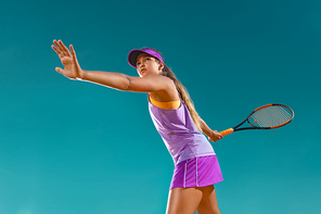 Beautiful girl tennis player with a racket on dark background wiht lights