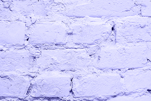 Lilac brick wall close up. Textured purple background color very peri 2022.