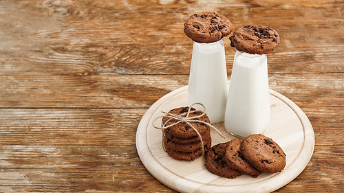 Homemade Chocolate Chip Cookies and Milk on wooden background in rustic style. Sweet snack. Place for text