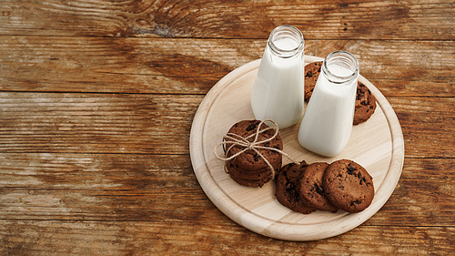 Homemade Chocolate Chip Cookies and Milk on wooden background in rustic style. Sweet snack. Place for text