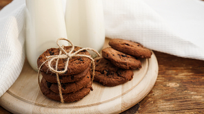 Homemade Chocolate Chip Cookies and Milk on wooden background in rustic style. Sweet snack
