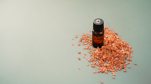 Beautiful spa composition with vial and orange sea salt for bath