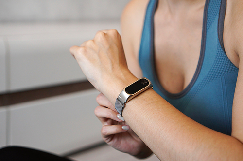 Close-up photo of sport girl using fitness tracker or heart rate monitor