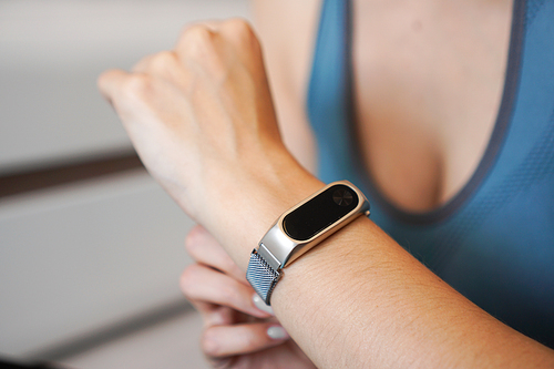 Close-up photo of sport girl using fitness tracker or heart rate monitor