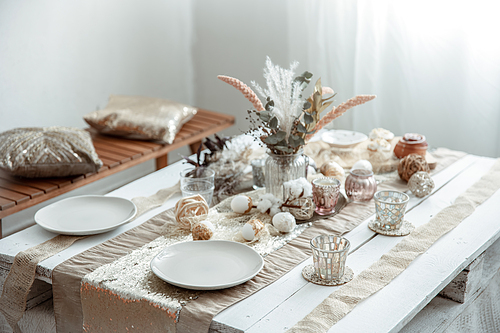 empty plates and glasses on a decorated dining table for the food holiday. beautiful hygge-style table setting.