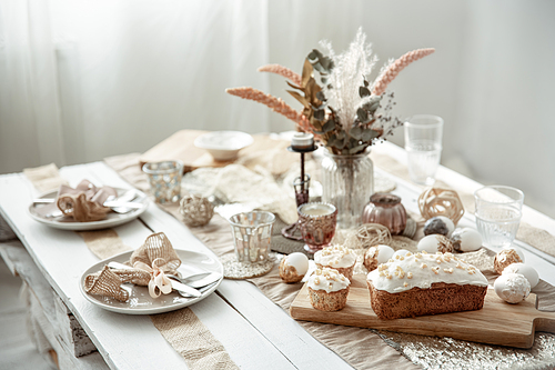 a festive table with a beautiful setting, decorative details, eggs and food cake.