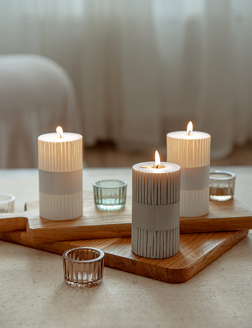 Close up of burning candles as a detail of home decor.