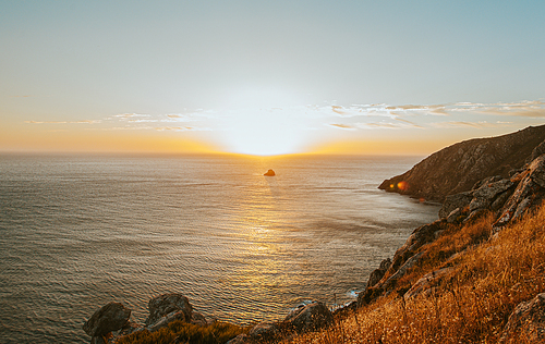An horizontal shot of a massive sunset in the Coast Of Death in Spain