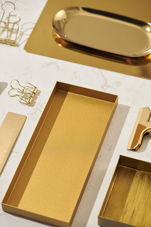 Gold items. Flat lay. Accessories on the table, woman desk top. View top table, background mock up. Envelope top