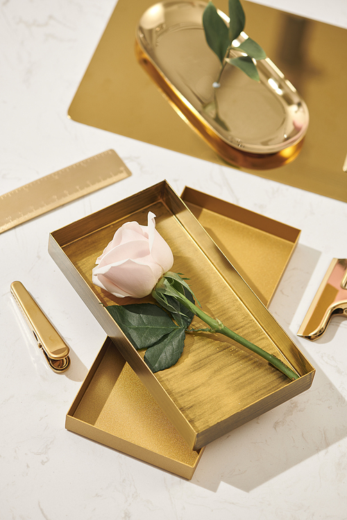 Gold items. Flat lay. Accessories on the table, woman desk top. View top table, background mock up. Envelope top