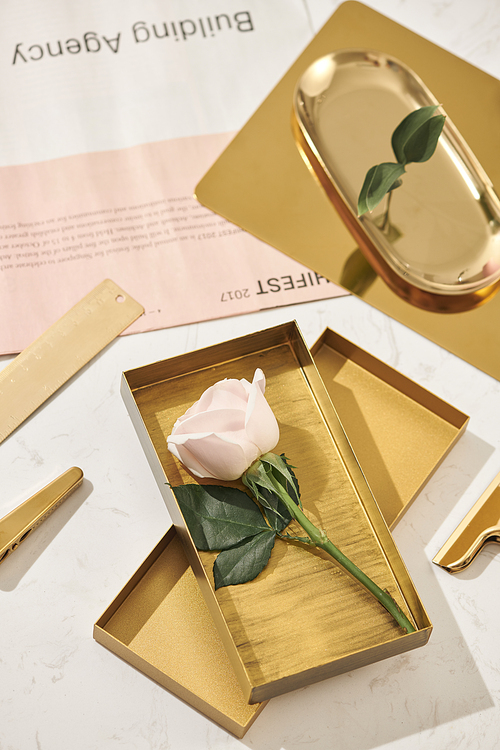 Gold items. Flat lay. Accessories on the table, woman desk top. View top table, background mock up. Envelope top