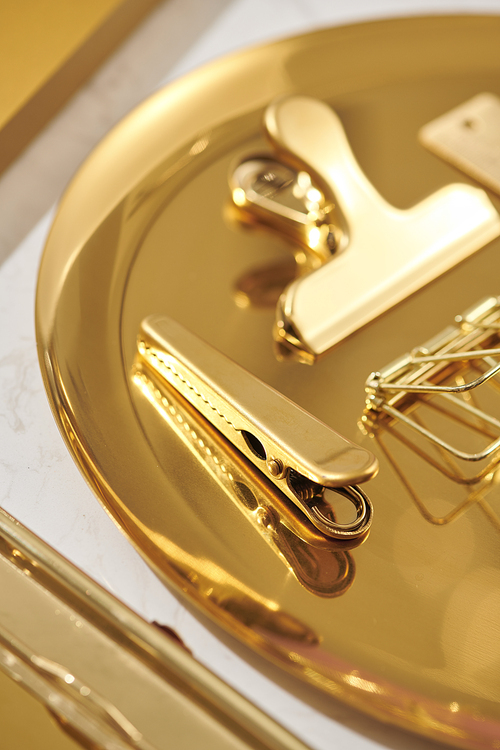 Gold items. Flat lay. Accessories on the table, woman desk top. View top table, background mock up. Envelope top