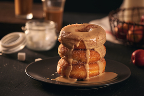 Close-up of donuts in stack with milk bottle and glass