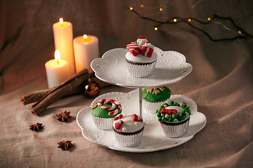 Christmas sweets: cupcakes closeup on a linen background.